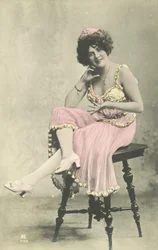 Actress with Nice Smile in Pink Dress Sitting on Stool
